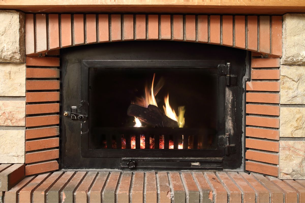 fireplace with stone and red brick surround. red brick hearth.