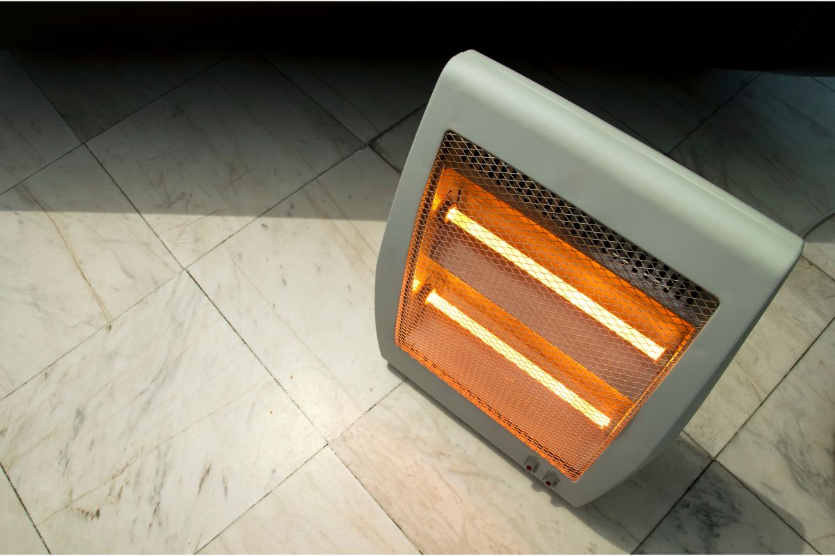 quartz heater on tiled floor with element burning