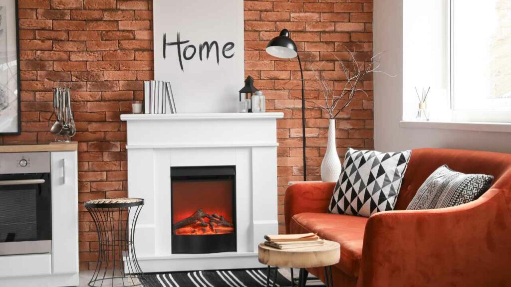 electric fireplace with white firplace surround. Brick wall behind.