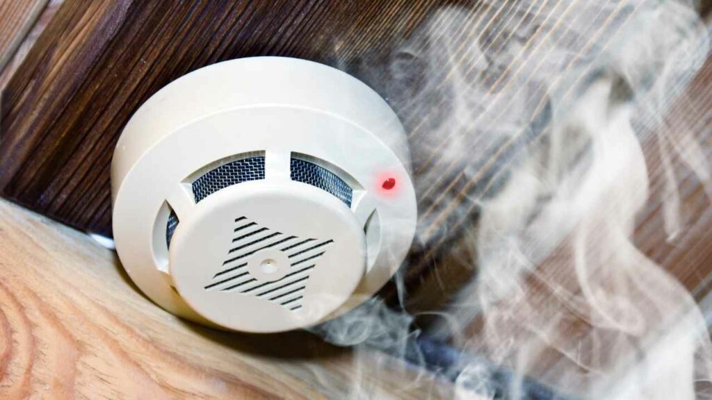 Smoke detector on ceiling. smoke rising towards the detector.