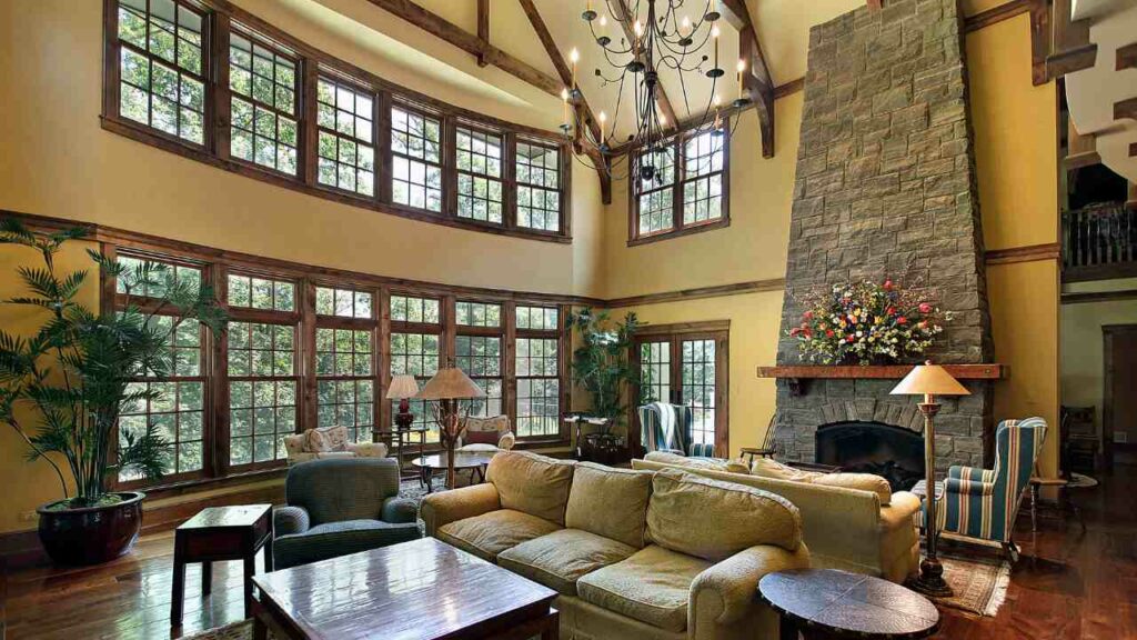 large stone fireplace, wood mantel. Huge windows to one side. two sofas,
