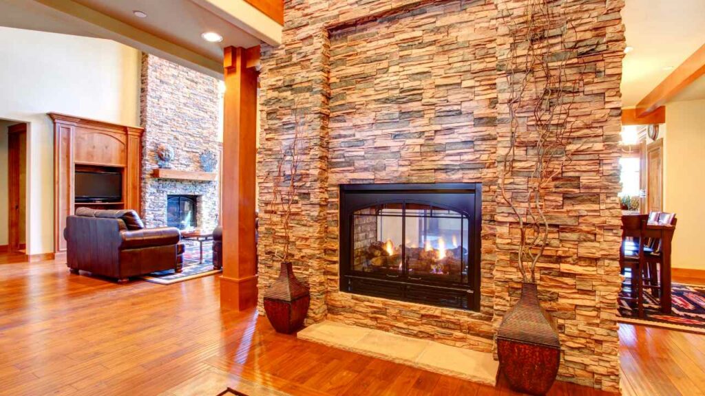 double sided stone fireplace with wood flooring