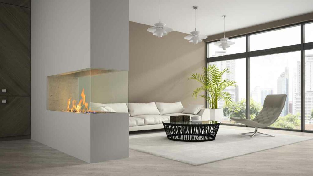 Long 3 sided fireplace. Modern Gas fireplace design. very large window and white leather sofa. City skyline through the windows.