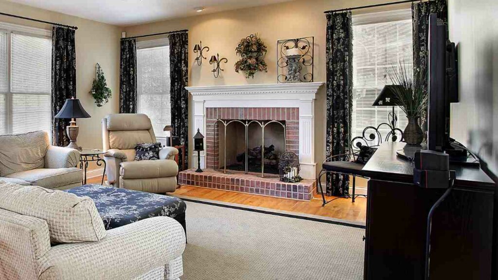 wood burning fireplace with fireguard, hearth and wood flooring. windows both sides.