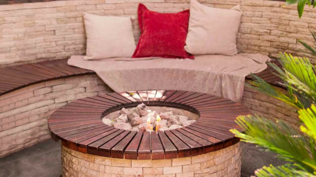 Circular outdoor brick fire pit. bench and cushions.