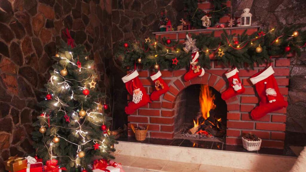 Red brick fireplace and surround. Wood burning. christmas decorations and stockings hanging from mantel. Christmas tree to the left.