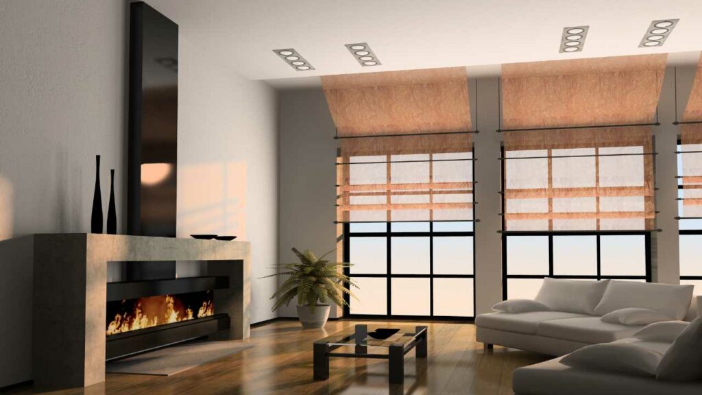 Modern fireplace. Large mantel. Wood flooring. Large windows. Plant to the side