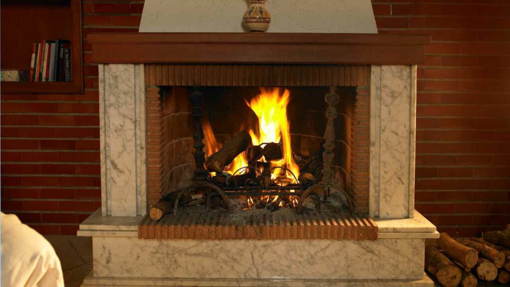 medieranean style fireplace. wood burning. Marble surround. book shelf oneside, wood store the other.