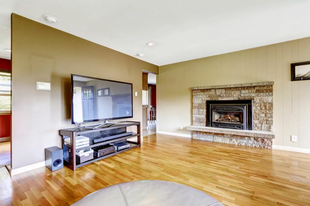 Stone Fireplace in living room with wood floor