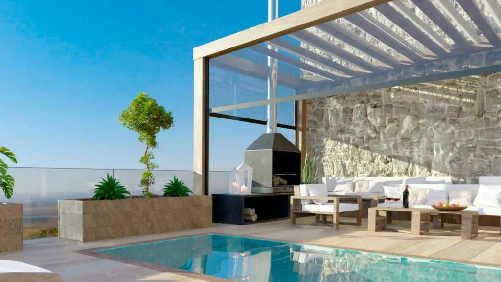 Swimmin pool with outdoor fireplace and pergola. Stunning views to the distance.
