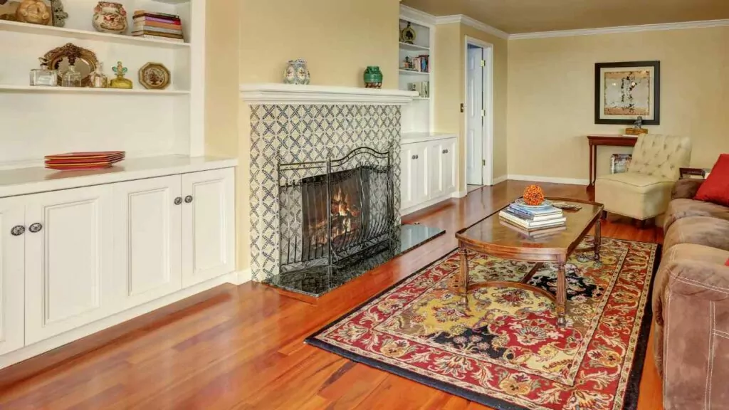Wood burning fireplace. Tile surround. Fireguard. Wood flooring. Shelves both side.