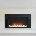 modern electric fireplace with white surround. wite pebble stone decoration.