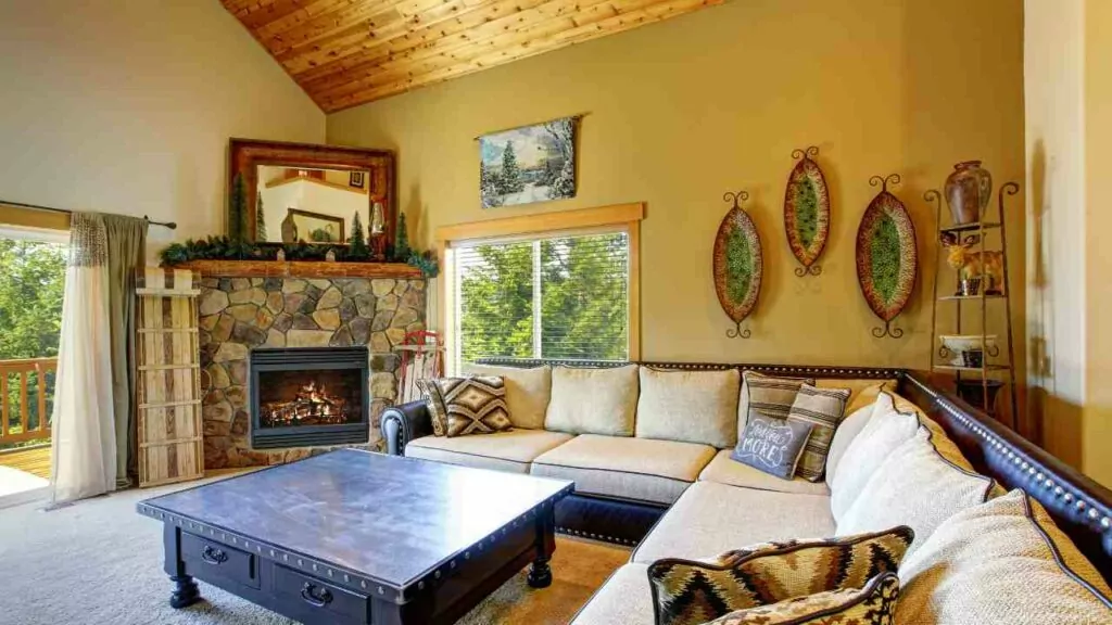 Corner fireplace with stone fireplace surround. Corner sofa with comfy seating. Large coffe table in front of the electric fireplace.